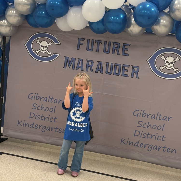 A future kindergarten student posing in front of a Gibraltar school district banner