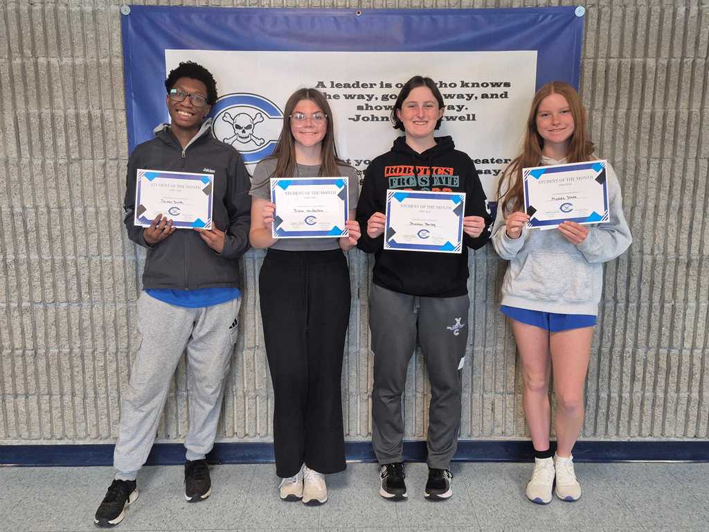 Four students holding award certificates