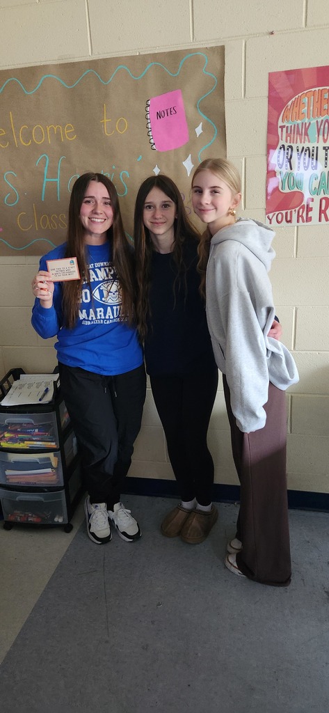 Three students stand together for a picture