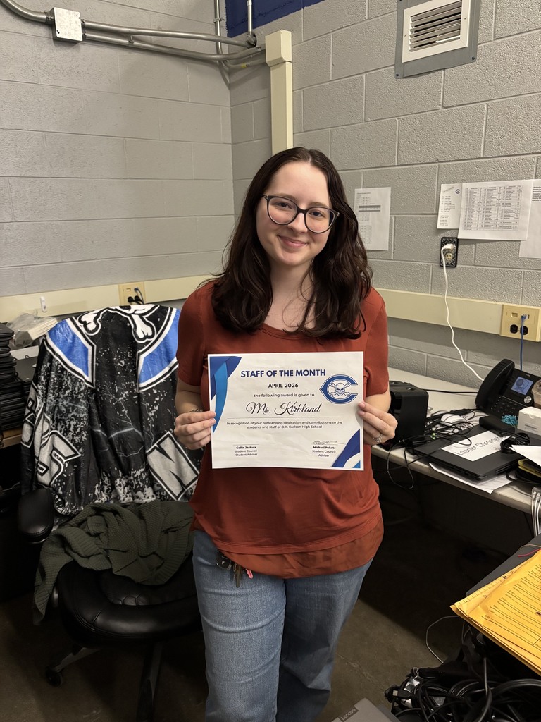 Ms. Kirkland holding an award