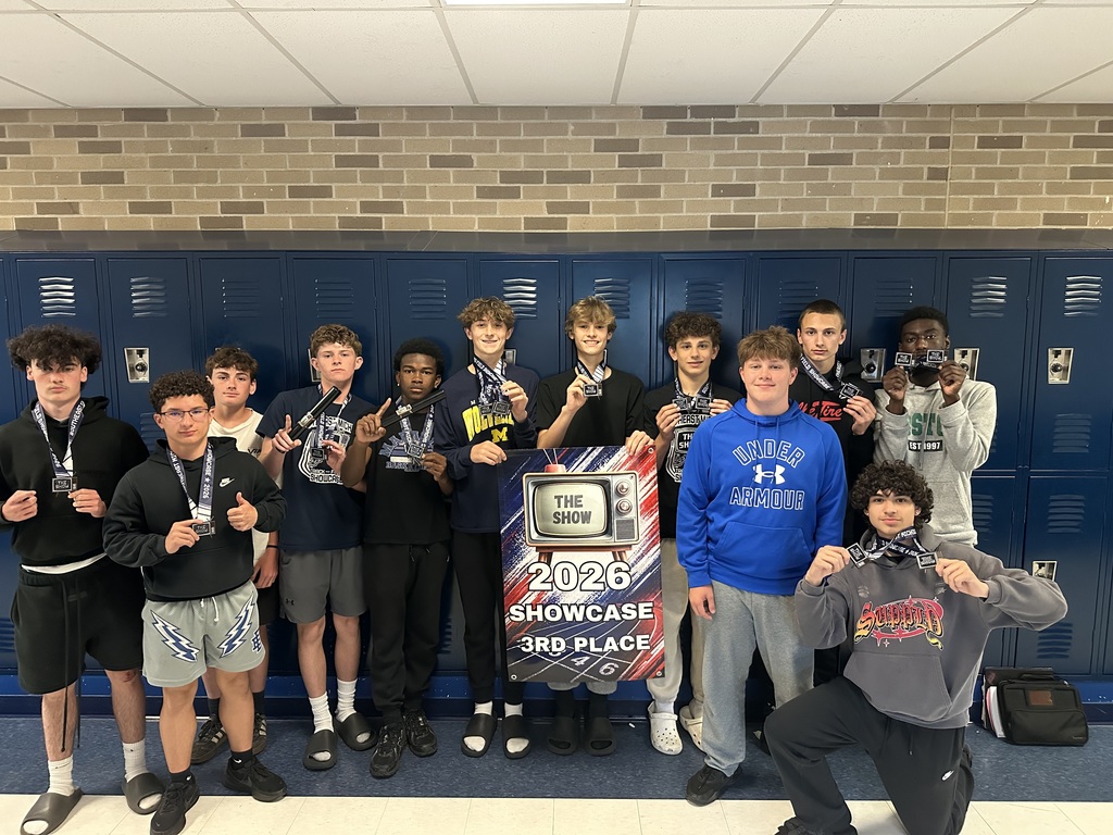 The Boys Track and Field team gathering around the 2026 Showcase 3rd Place Banner