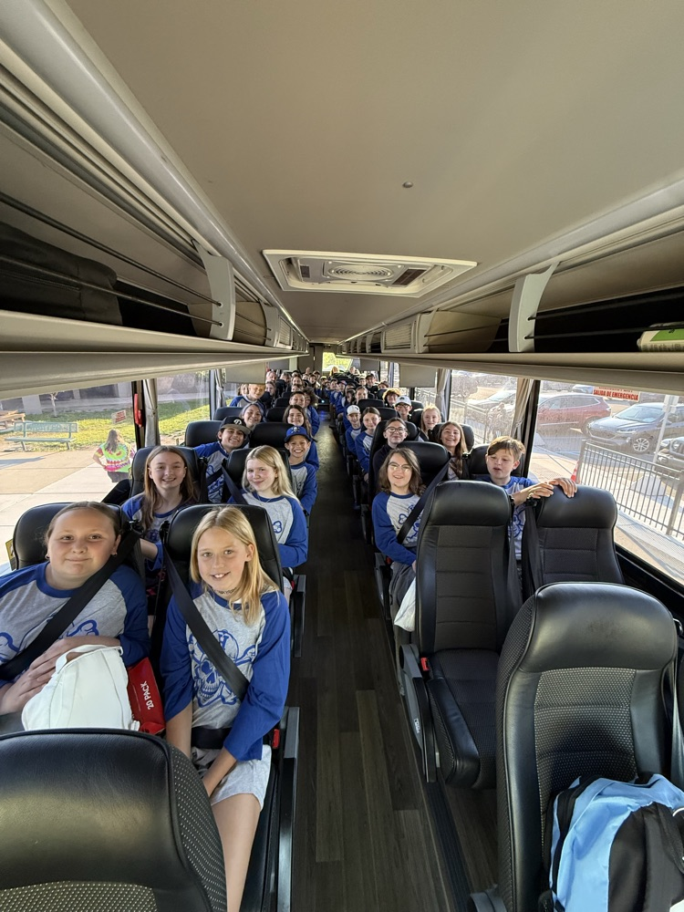 fifth grade students on the bus ready to go to fifth grade camp