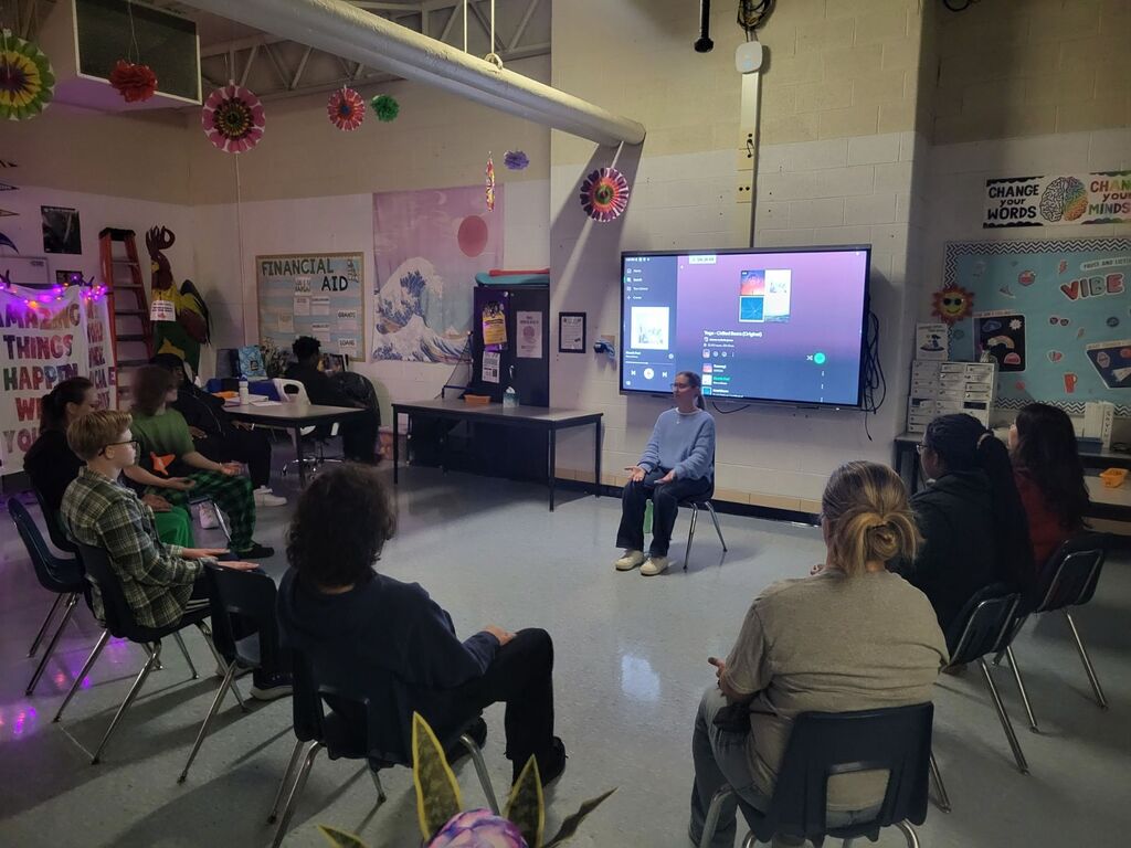 Students sit in a circle doing mindfulness activities, led by counselor Ms. Laginess.