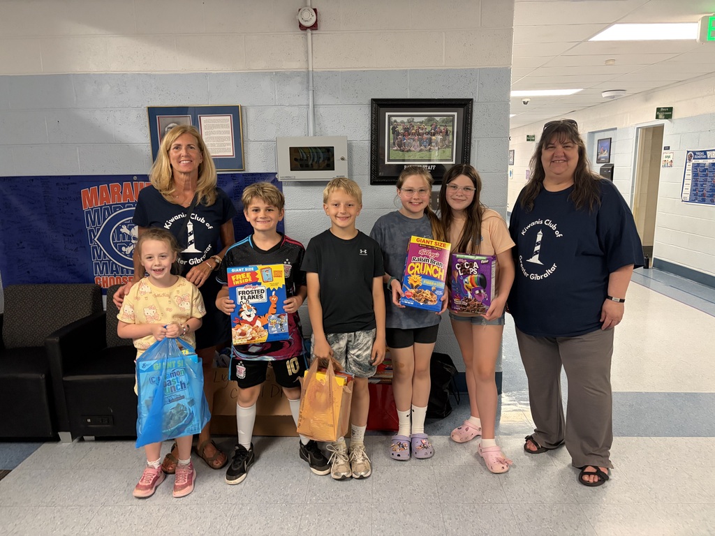 Kiwanis Club members with five elementary students during a Cereal Drive.