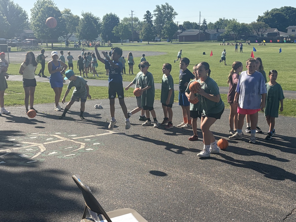 Fourth graders playing basketball gam.