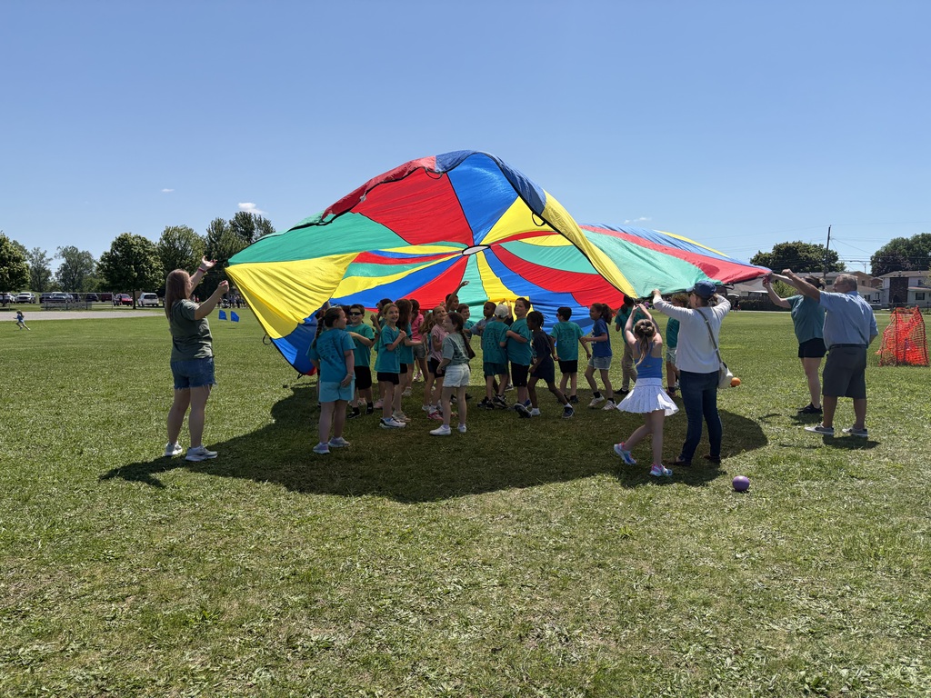 Students playing with a parachute at field day.
