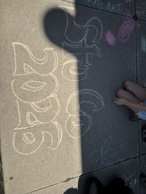 Sidewalk chalk drawing says StuCo 2026