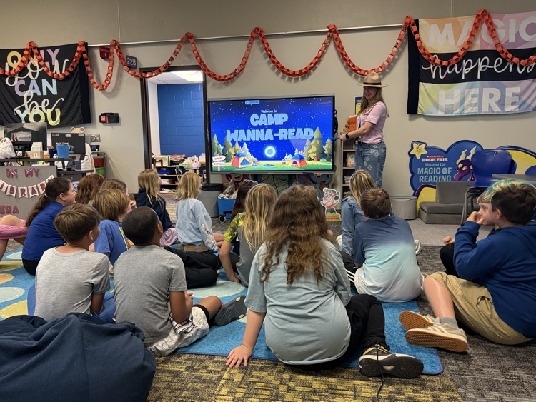 Image of elementary students sitting in and being introduced to stations
