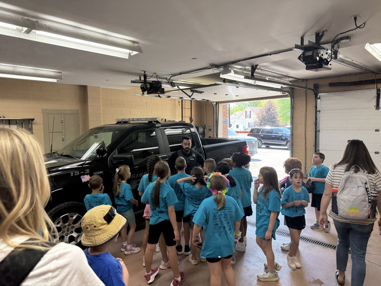students looking at the police truck