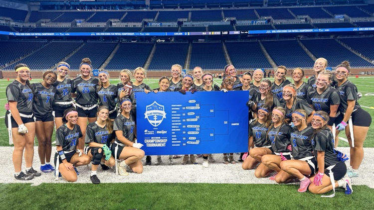 flag football team posing with backet 