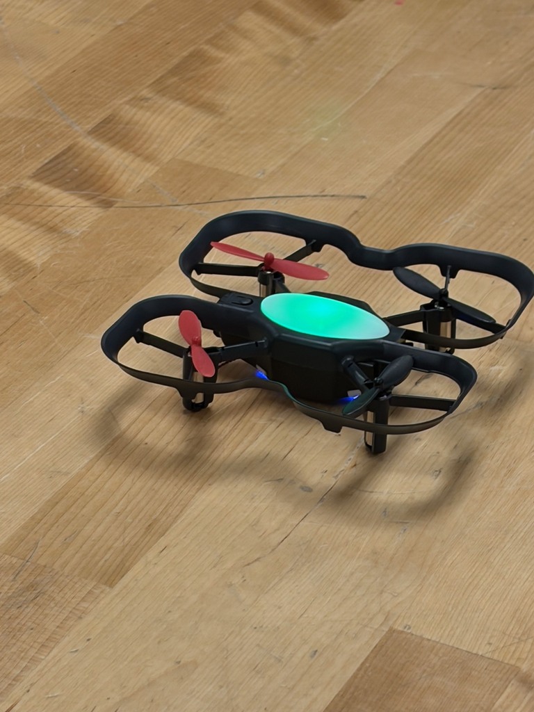 A drone with a green light in the middle