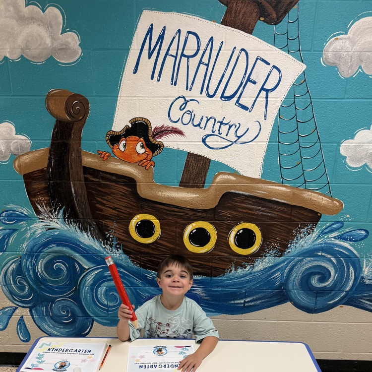student signing kindergarten letter