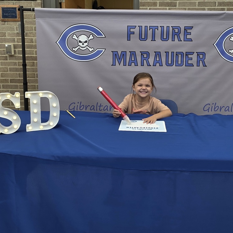 student signing kindergarten letter