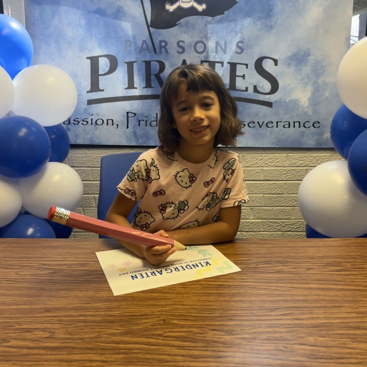 student signing kindergarten letter