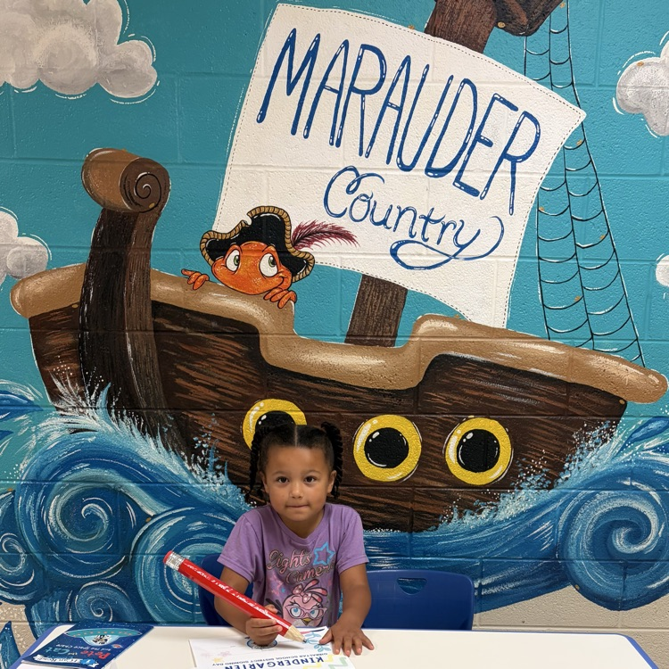 student signing kindergarten letter