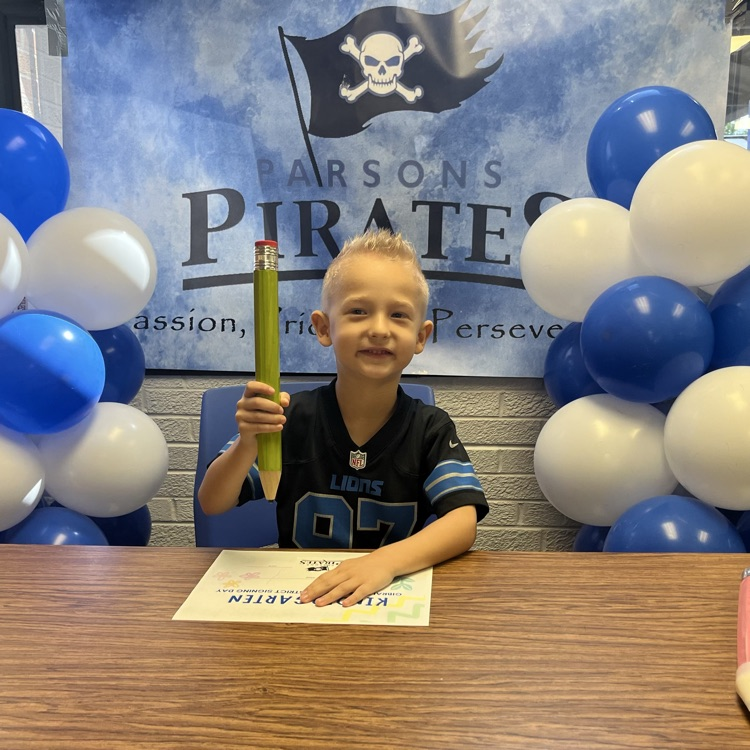 student signing kindergarten letter