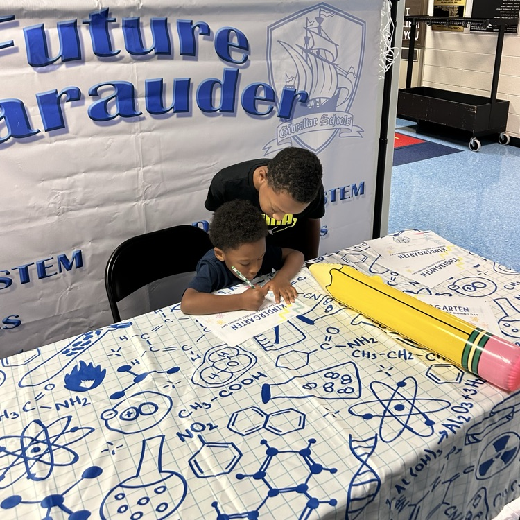 student signing kindergarten letter