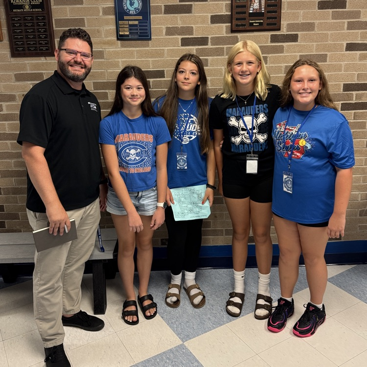students standing with assistant principal