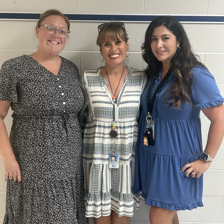 three teachers smiling in group photo 