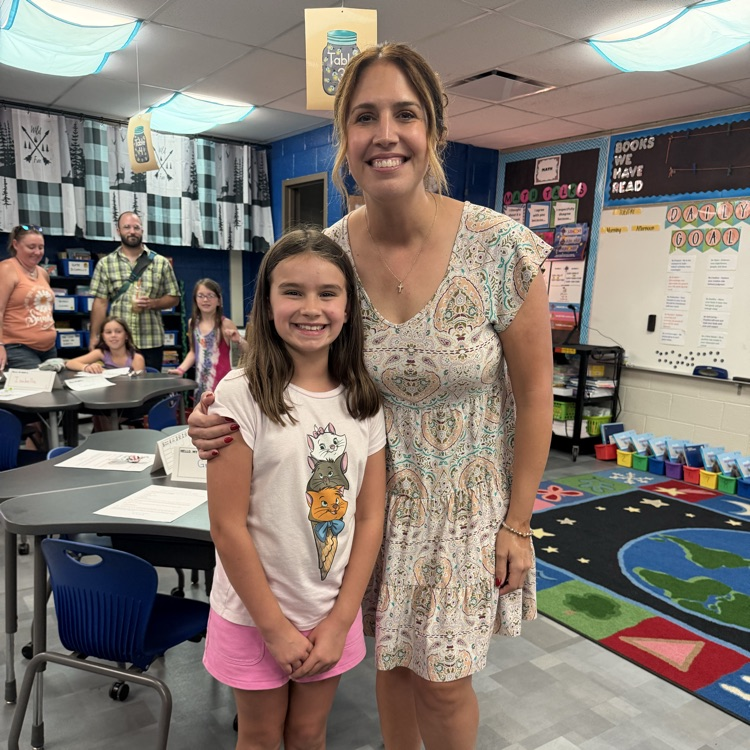 teacher standing with a student