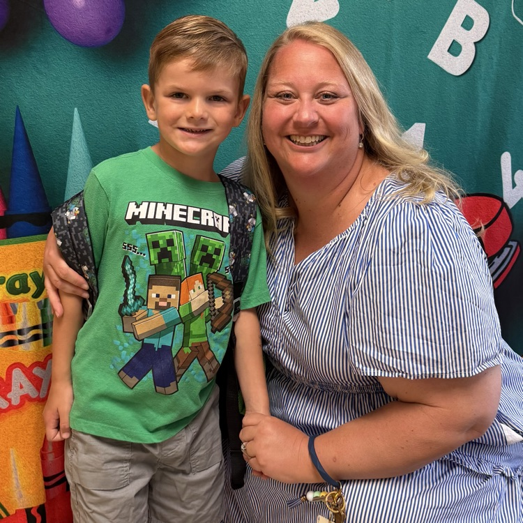 student and teacher posing for a picture