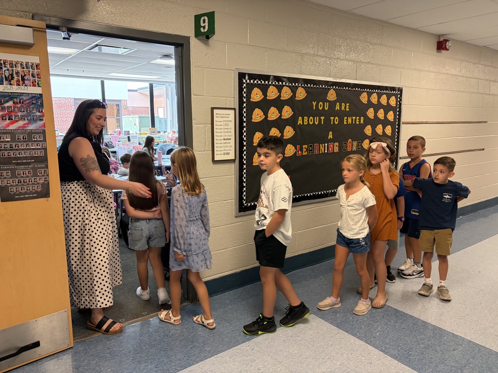 Teacher greeting third graders
