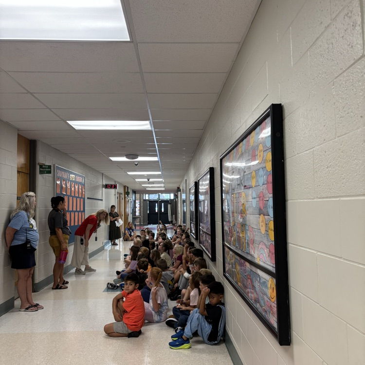 Students participate in PBIS rotations throughout the school, listening and looking attentively as teachers review school-wide expectations and rules.