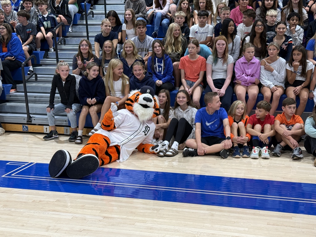 Paws, the Tigers mascot, poses in front of students