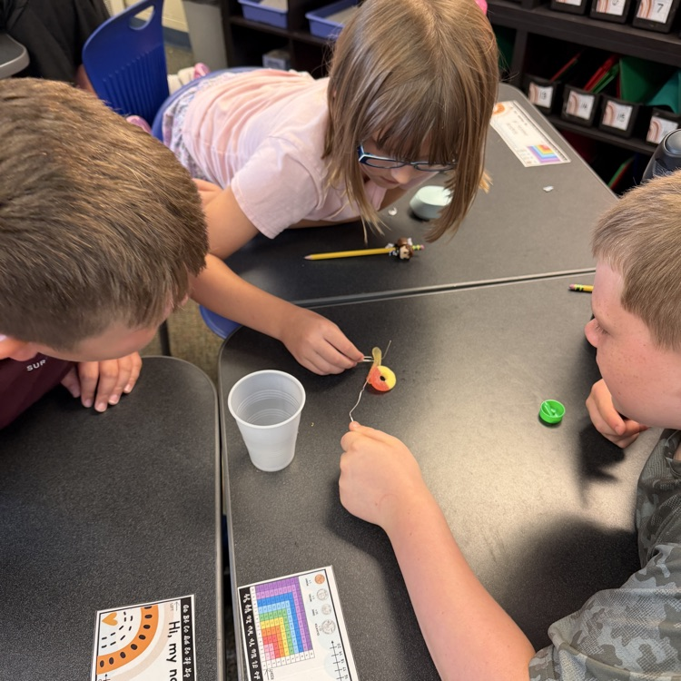 Students work together during a “Saving Fred” activity, using teamwork, communication, and problem-solving skills to rescue Fred without using their hands.