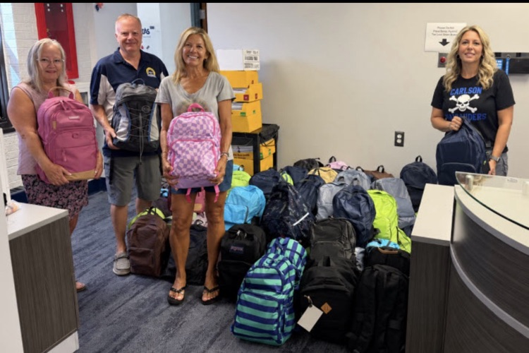 Sunseeker boating club and superintendent posing with backpack donations
