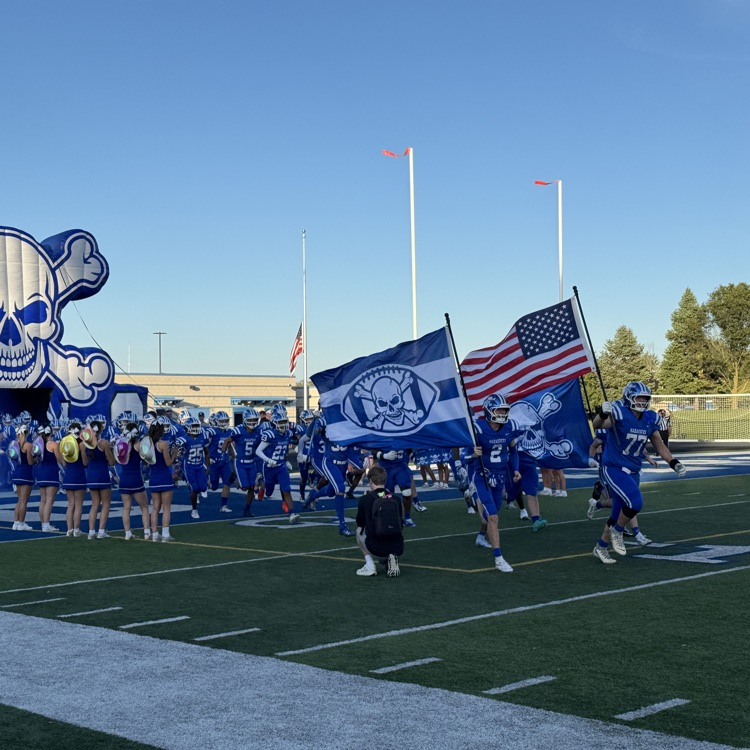 Carlson football team running out to the field