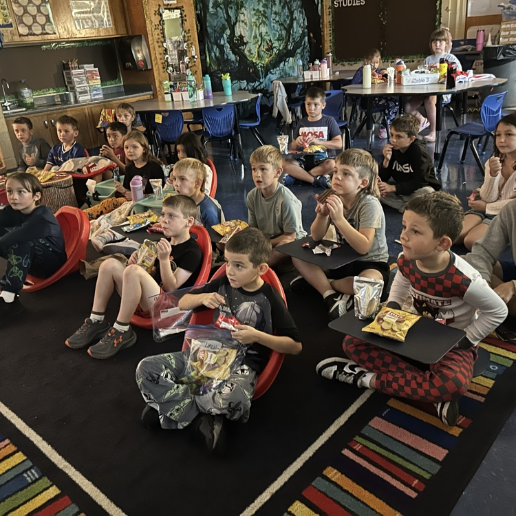 Students sit in their classroom enjoying snacks while watching a movie during Chapman’s PBIS Movie Theater.
