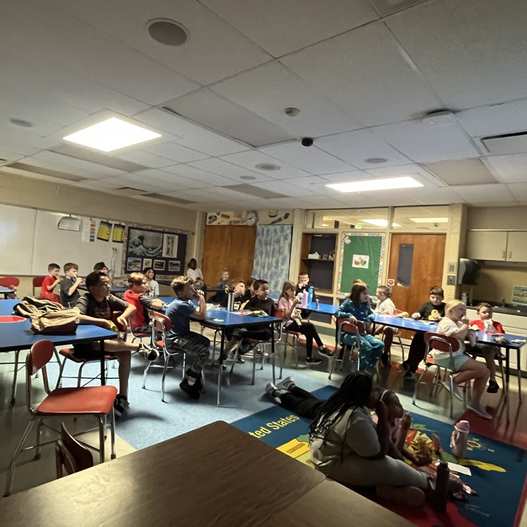 Students sit in their classroom enjoying snacks while watching a movie during Chapman’s PBIS Movie Theater.