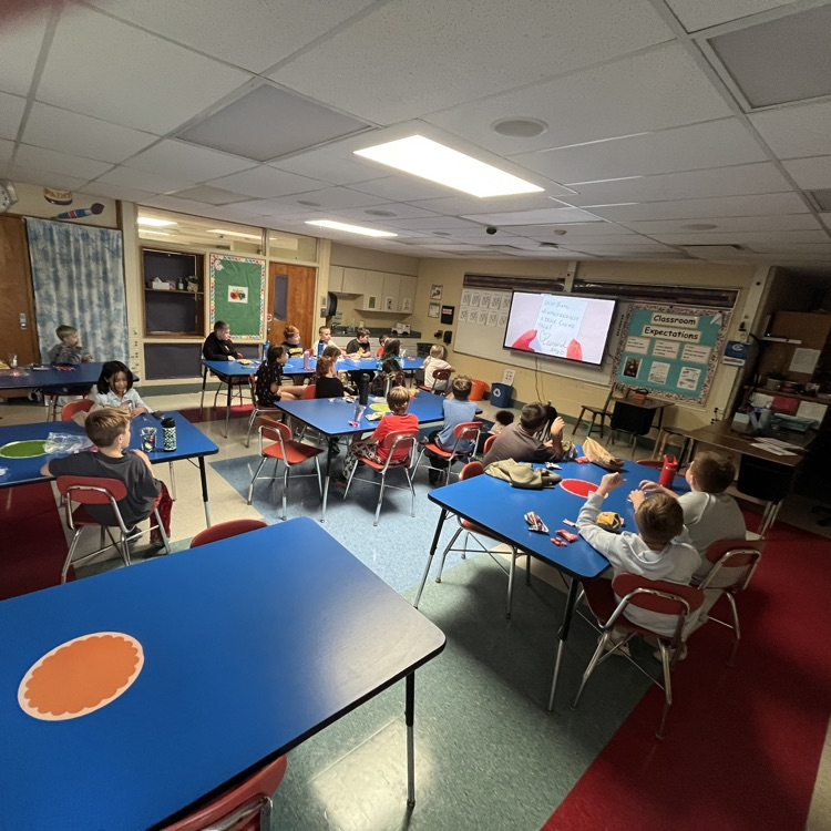 Students sit in their classroom enjoying snacks while watching a movie during Chapman’s PBIS Movie Theater.