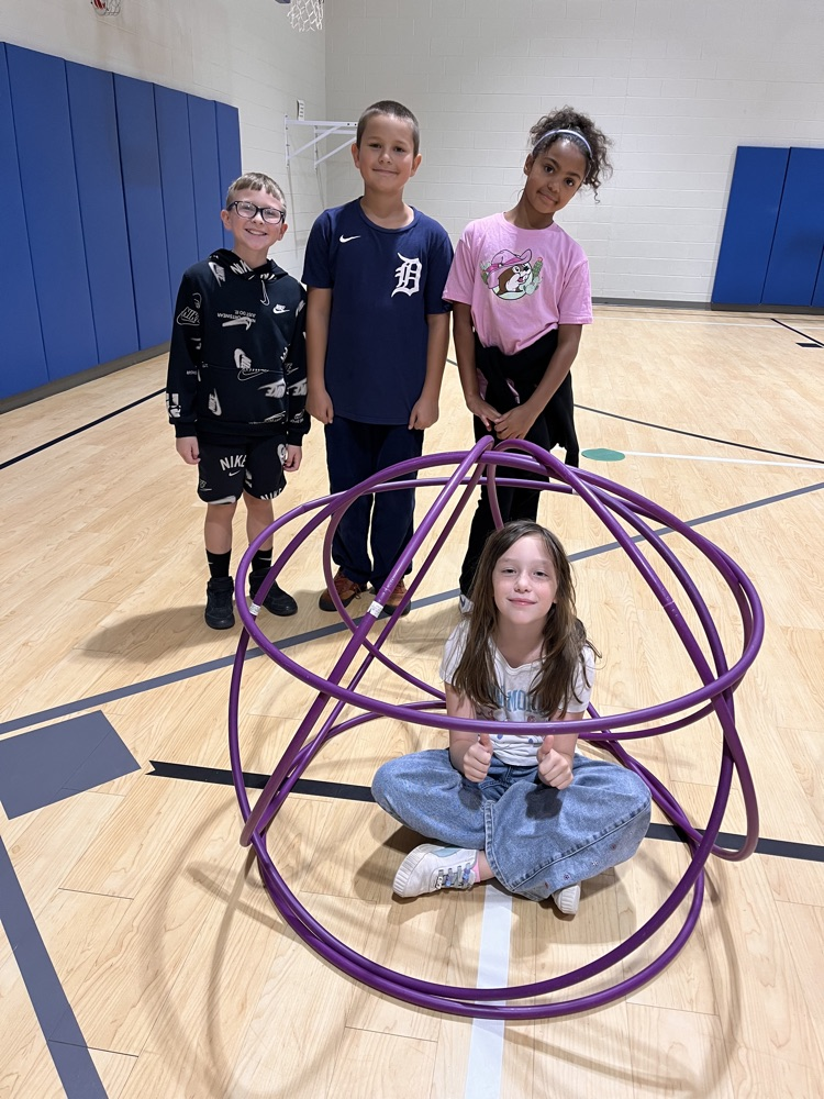 Chapman third- through fifth-grade students pose proudly in front of the hula huts they built during Physical Education.