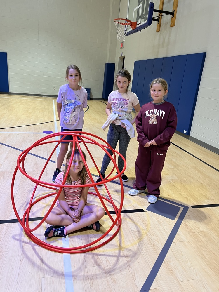 Chapman third- through fifth-grade students pose proudly in front of the hula huts they built during Physical Education.
