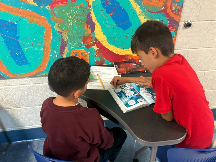 older and younger students reading together