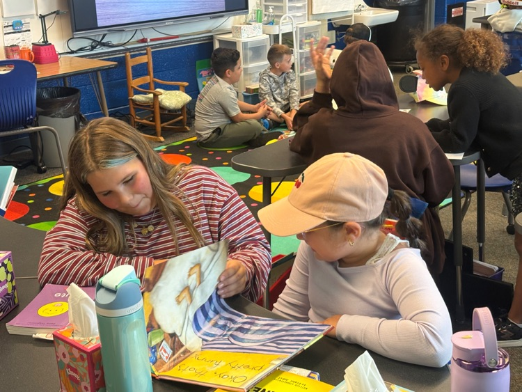 older and younger students reading together