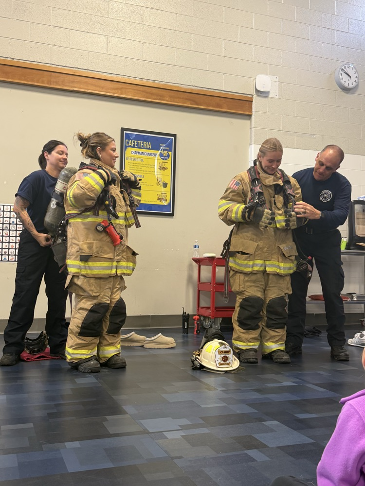 K–2 students sitting together during the fire safety assembly. The fire chief talking to students about fire safety.