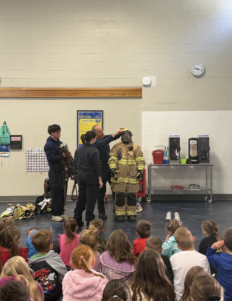 K–2 students sitting together during the fire safety assembly. The fire chief talking to students about fire safety.