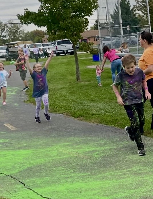 students running in a color run
