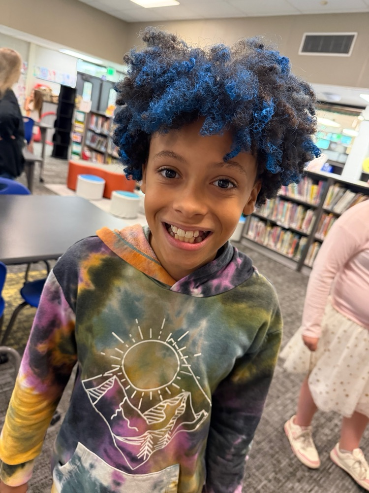 Students showing off their crazy hairstyles and fun socks for Spirit Week.
