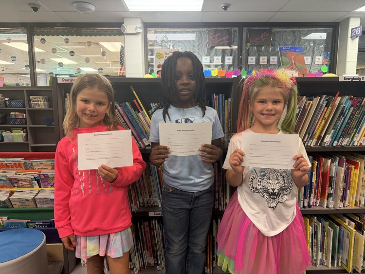 students holding up lists of books they would like to see in our Chapman library