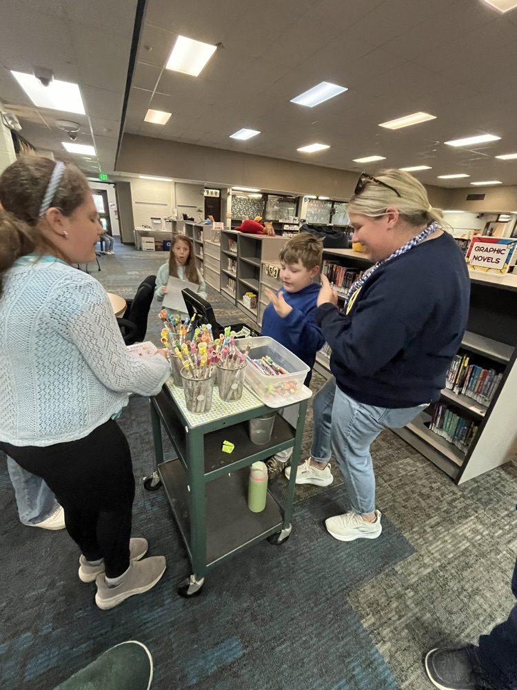 Alt text: Chapman students shop for colorful, scented Smencils from a classroom cart during the Peer to Peer Program’s Smencil Sale.