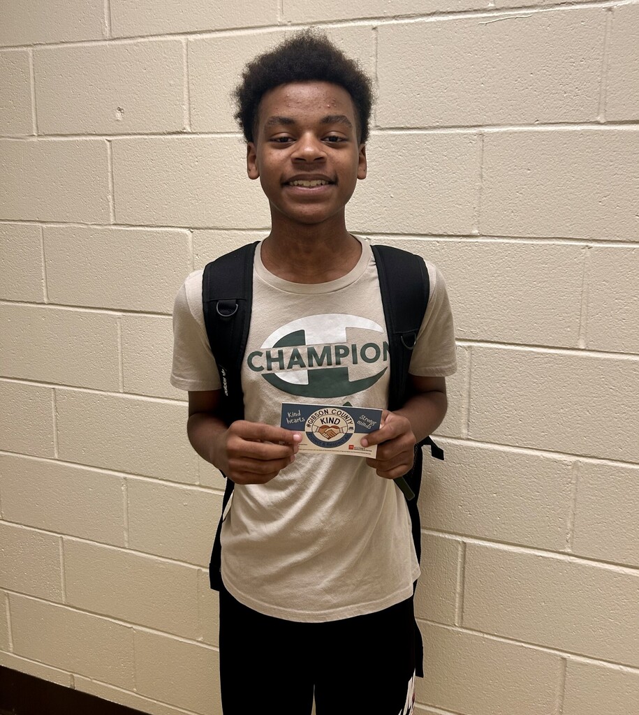 picture of 10th grade male student in the hallway holding a Gibson County Kind sticker