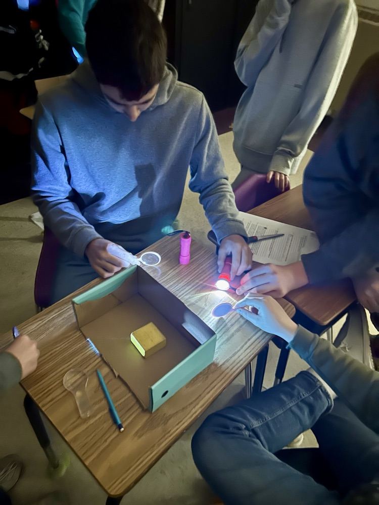 8th grade had to design a security system to protect a gem using the properties of light.