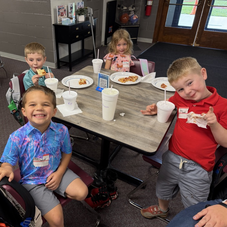 Enjoying their pizza.