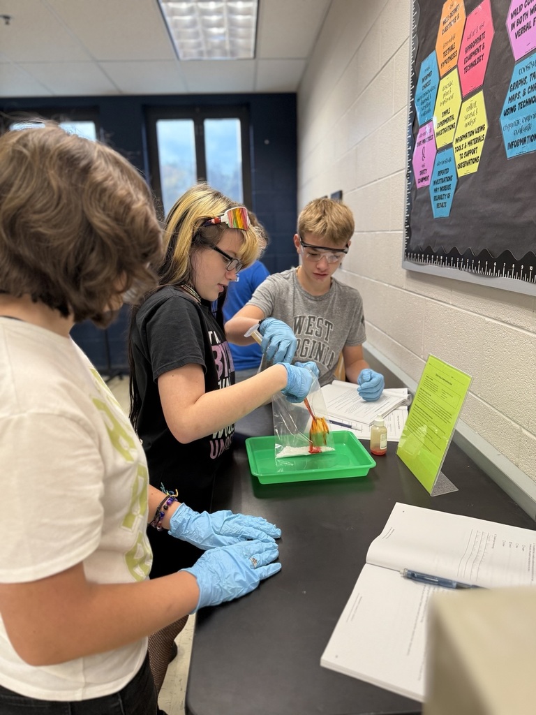 three students work together with scientific equipment