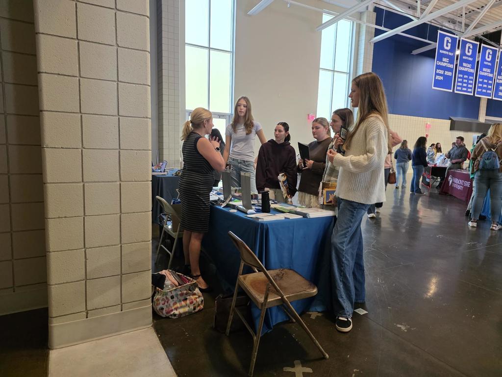 students in a huddle around a rep