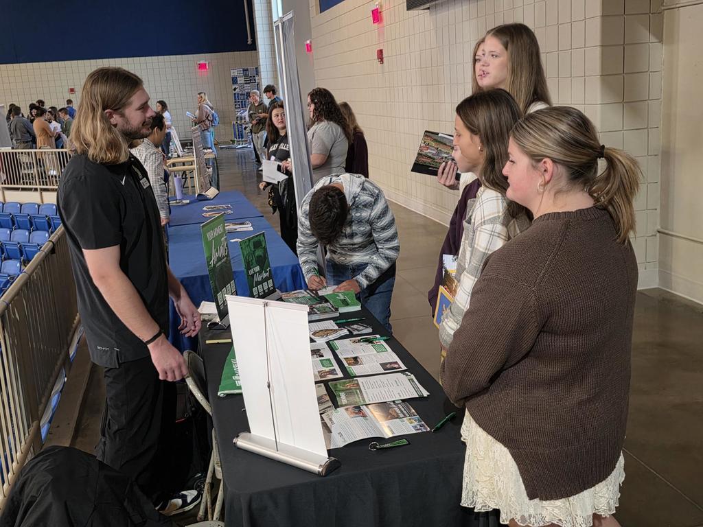 students talking with a rep